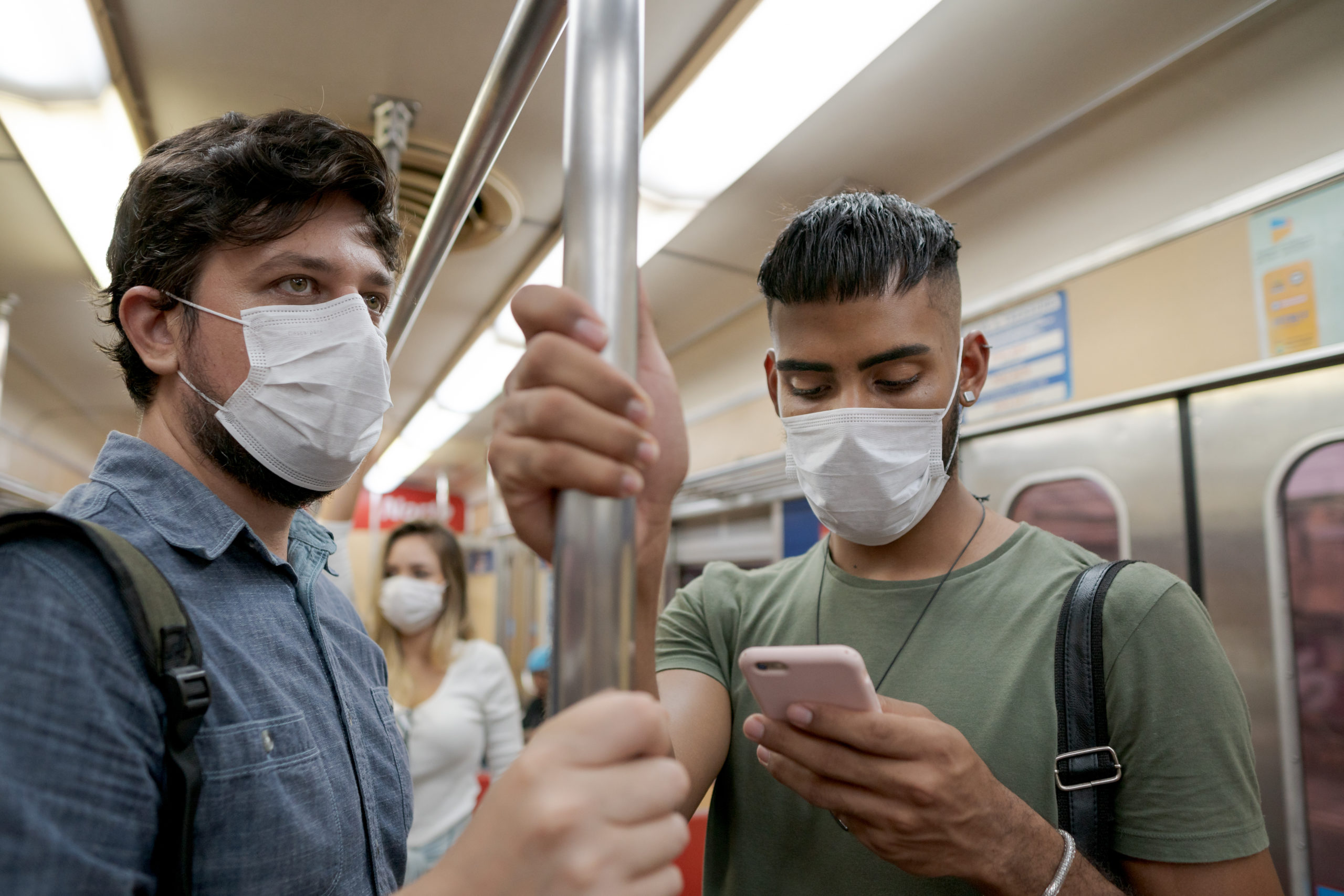 Students and travelers using public transport for commuting. Covid-19 and CoronaVirus concept. People wearing masks on the train. Students and travelers using public transport for commuting. Covid-19 and CoronaVirus concept. People wearing masks on the train.